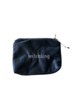 A dark navy blue velvet pouch with the word 'witchling' embroidered in white gothic lettering on the front, featuring a gold zipper pull, set against a solid white background.